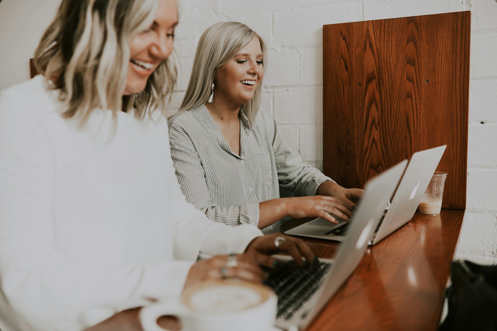 two women using laptops building a successful brand article the gal project