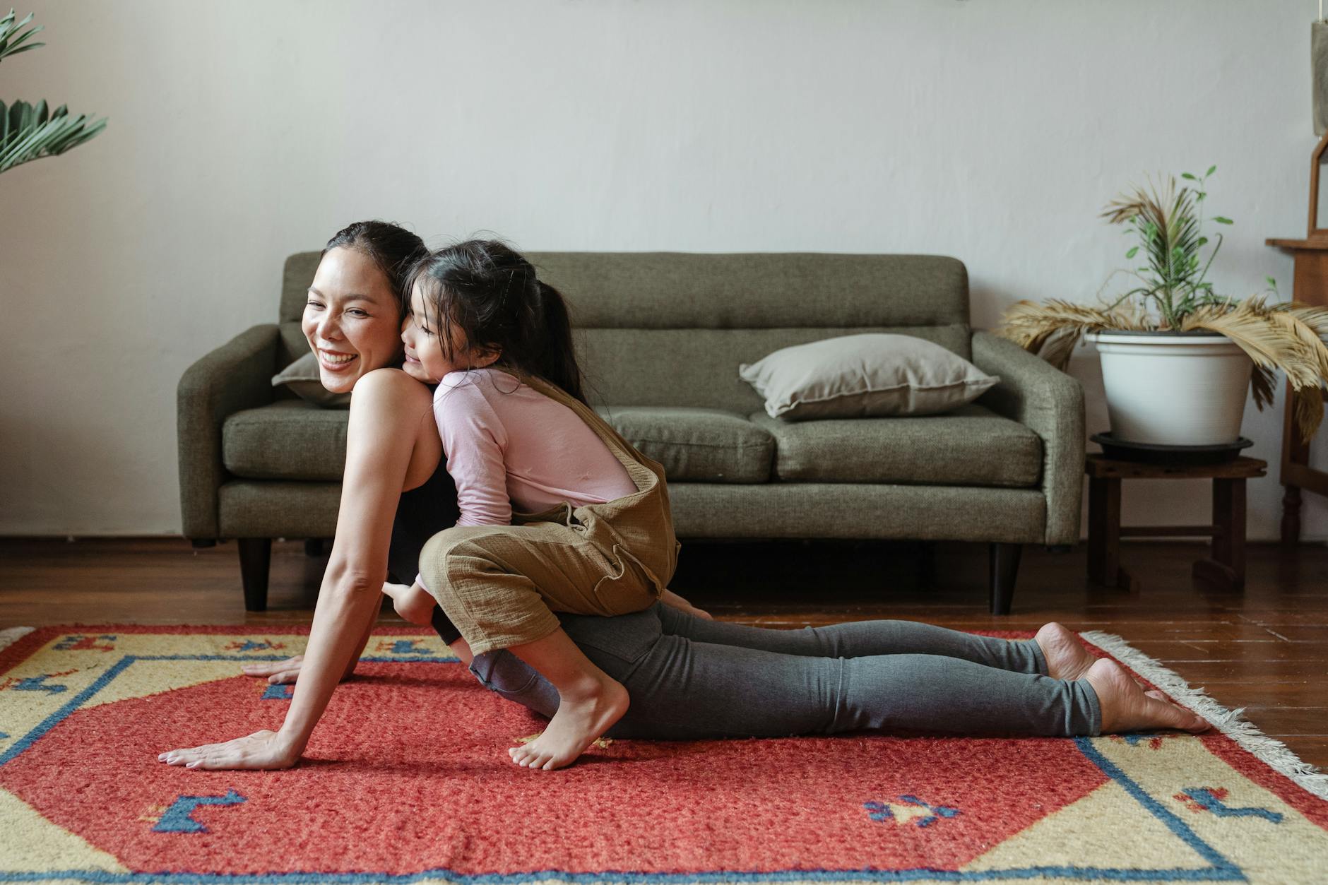 photo of girl hugging her mom while doing yoga pose. work-life balance for women