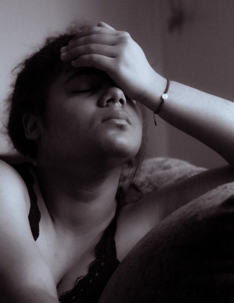 Hot Flashes During Perimenopause: What They Feel Like and How to Cope 1 a black and white photo of a woman sitting on a couch. hot flashes and perimenopause